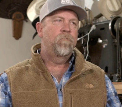 Employee-owner Ron Mann wearing a grey baseball cap, flannel shirt, and brown vest.